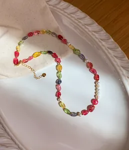 Close-up of a colorful dopamine candy-colored crystal beaded necklace with pearls on white tray