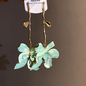 Elegant mint green enamel flower drop earrings with golden branch design for vacation