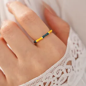 Close-up shot of a vintage colorful enamel bamboo joint open ring worn on a finger