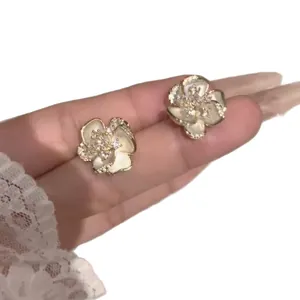 Elegant white camellia flower stud earrings with sparkling crystals for a retro chic look