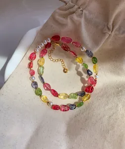 Macro view of multi-color candy crystal beads and white pearls on a natural linen bag