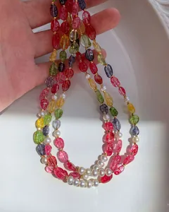 Macro view of colorful candy-colored crystal beads and freshwater pearls on a necklace.