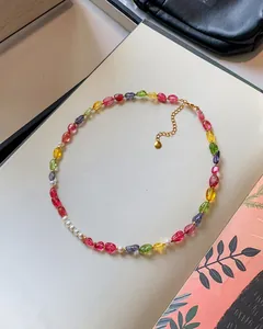 Detailed view of the vibrant candy-colored beads and pearls of the handmade necklace