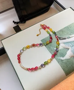 Detailed shot of a vibrant candy-colored crystal and pearl beaded necklace set on a fashion book