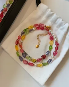 Detail view of a colorful dopamine candy-style pearl and crystal beaded necklace