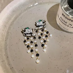Vintage palace style panther head earrings with white pearl tassels and crystal pavé