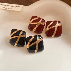 Minimalist square enamel stud earrings featuring gold abstract geometric patterns