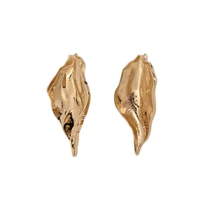 Gold irregular leaf earrings with a metallic crinkle texture in minimalist style