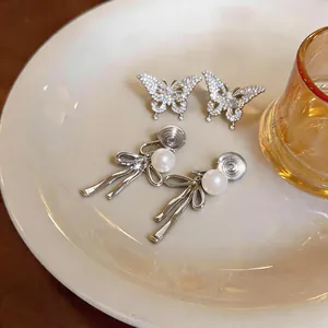 Elegant butterfly and pearl bow clip-on earrings for women with no piercings.