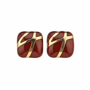 Square burgundy enamel stud earrings with gold geometric lines and silver needles