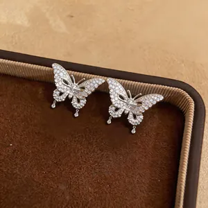Detailed close-up of exquisite butterfly ear clips with pave-set shimmering cubic zirconia