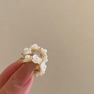 Detail of French style hoop earrings with white flowers and pearls