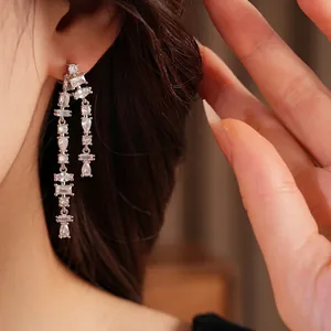 Elegant silver needle long tassel earrings with sparkling cubic zirconia stones on model