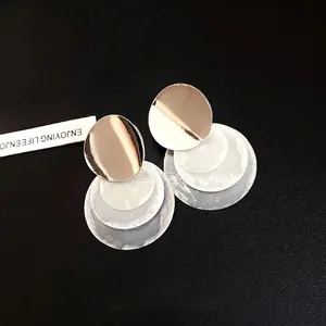 Elegant minimalist silver needle earrings with golden studs and layered white round shell pendants