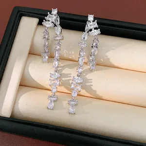 Detailed macro shot of sparkling cubic zirconia long tassel earrings in a gift box.