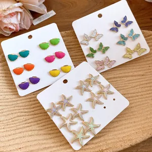 Detailed view of a 12-piece earring set with colorful starfish and butterfly motifs.