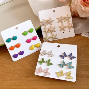 Detailed view of colorful enamel starfish and butterfly stud earrings in a 12-piece set.