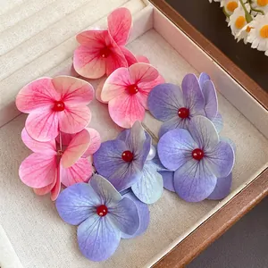 Romantic floral drop earrings with pearls in pink and purple for seaside vacations