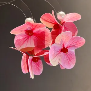 Elegant pink flower tassel earrings with white pearls for a trendy beach vacation style.