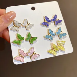 Detailed view of 12-piece colorful enamel butterfly stud earrings with gold plating