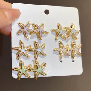 Close-up of 12-piece set of colorful enamel starfish stud earrings on a card.