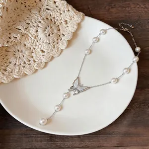 Elegant 18K gold plated beaded necklace featuring a zircon butterfly pendant on a white plate.