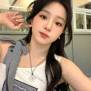 Asian model wearing sparkling zircon star earrings and flower pendant necklace