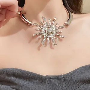 Close-up of a metallic sun-shaped choker necklace with radiant rays on a female model.