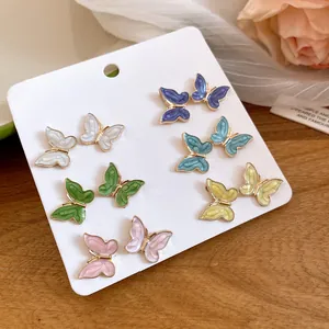 Detailed view of twelve piece butterfly stud earrings set in six vibrant enamel colors