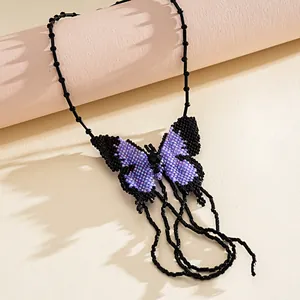 Close-up of a handmade purple and black beaded butterfly necklace with intricate details