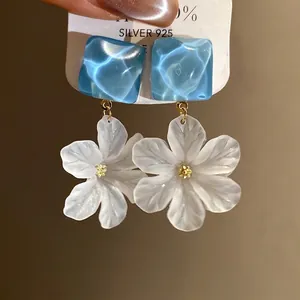 Elegant blue acrylic and white flower pendant earrings with silver needles