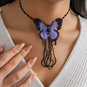 Intricate detail of handmade color-block seed bead butterfly choker necklace with fringe