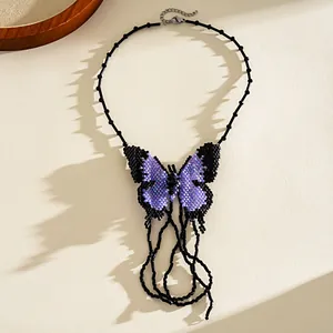 Handmade beaded butterfly necklace detail showing intricate purple and black seed beadwork