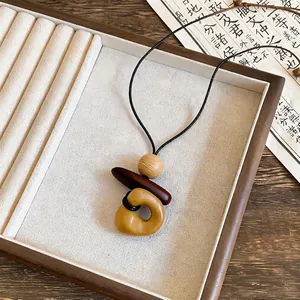 Maillard style amber geometric resin pendant long necklace for women vintage chic.