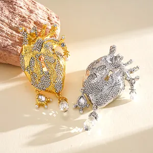 Detailed view of luxury rhinestone anatomical heart brooches with elegant glass drops
