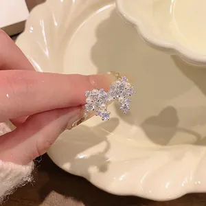 Detail view of a sparkling silver butterfly ring with delicate pearls and zirconia