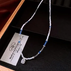 Elegant dopamine style beaded necklace with blue crystals and clear gemstone pendant