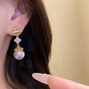 Elegant 18k gold plated flower earrings with zircon stones and a large drop pearl charm