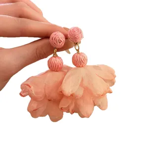 Elegant pink raffia and chiffon flower drop earrings for a bohemian holiday look.