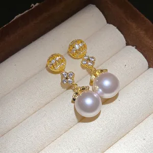 Elegant 18k gold plated drop earrings featuring zircon flowers and lustrous white pearls