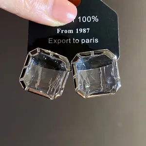 Elegant large square crystal stud earrings with a silver-tone metal setting for women.