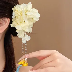 Elegant cream fabric flower hair clip with pearl tassels for a romantic Bohemian look