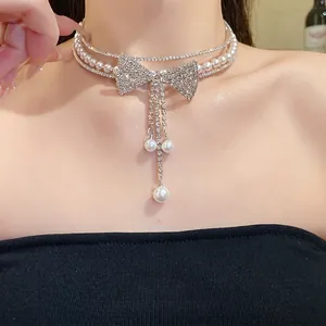 Elegant multi-layer choker necklace with pearl beads and sparkling rhinestone bow