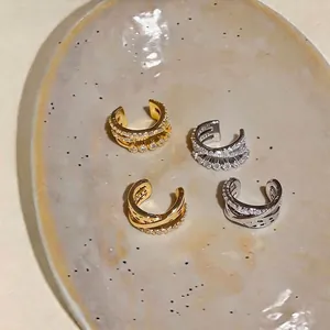 Clips de oreja cruzados de tres capas con circón, diseño sin agujeros en dorado y plata.