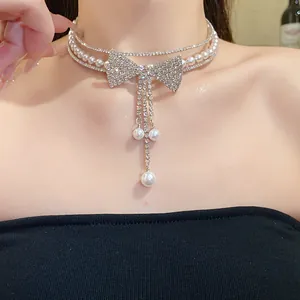 Detailed close-up of a double-layer pearl and rhinestone bow choker necklace on a model