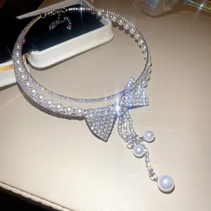 Close-up detail of multi-layered pearl choker necklace with sparkling rhinestone bow