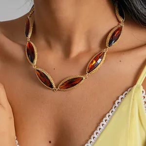 Exquisite detail view of a luxury marquise-cut amber stone necklace with gold textured frame