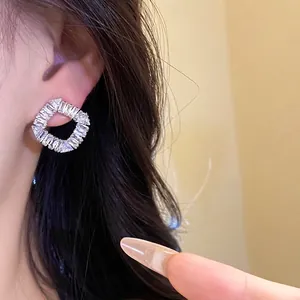 Boucles d'oreilles carrées ajourées vintage avec zircons étincelants sur modèle