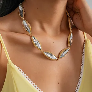 Detail view of luxury marquise-cut crystal necklace in gold finish on model