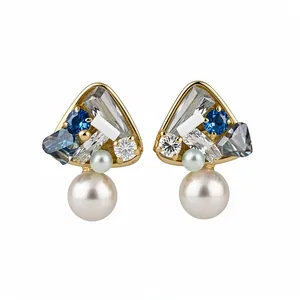 Elegant 18K gold plated geometric stud earrings with dangling pearls and blue crystals.